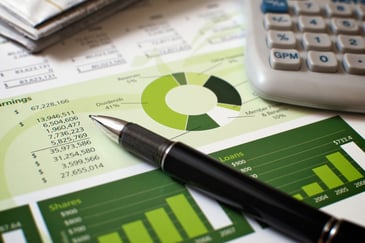 Black-pen-with-financial-figures-and-calculator-000010012145_Large
