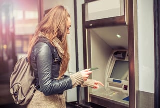Young-woman-taking-money-from-ATM-000090495725_Medium.jpg